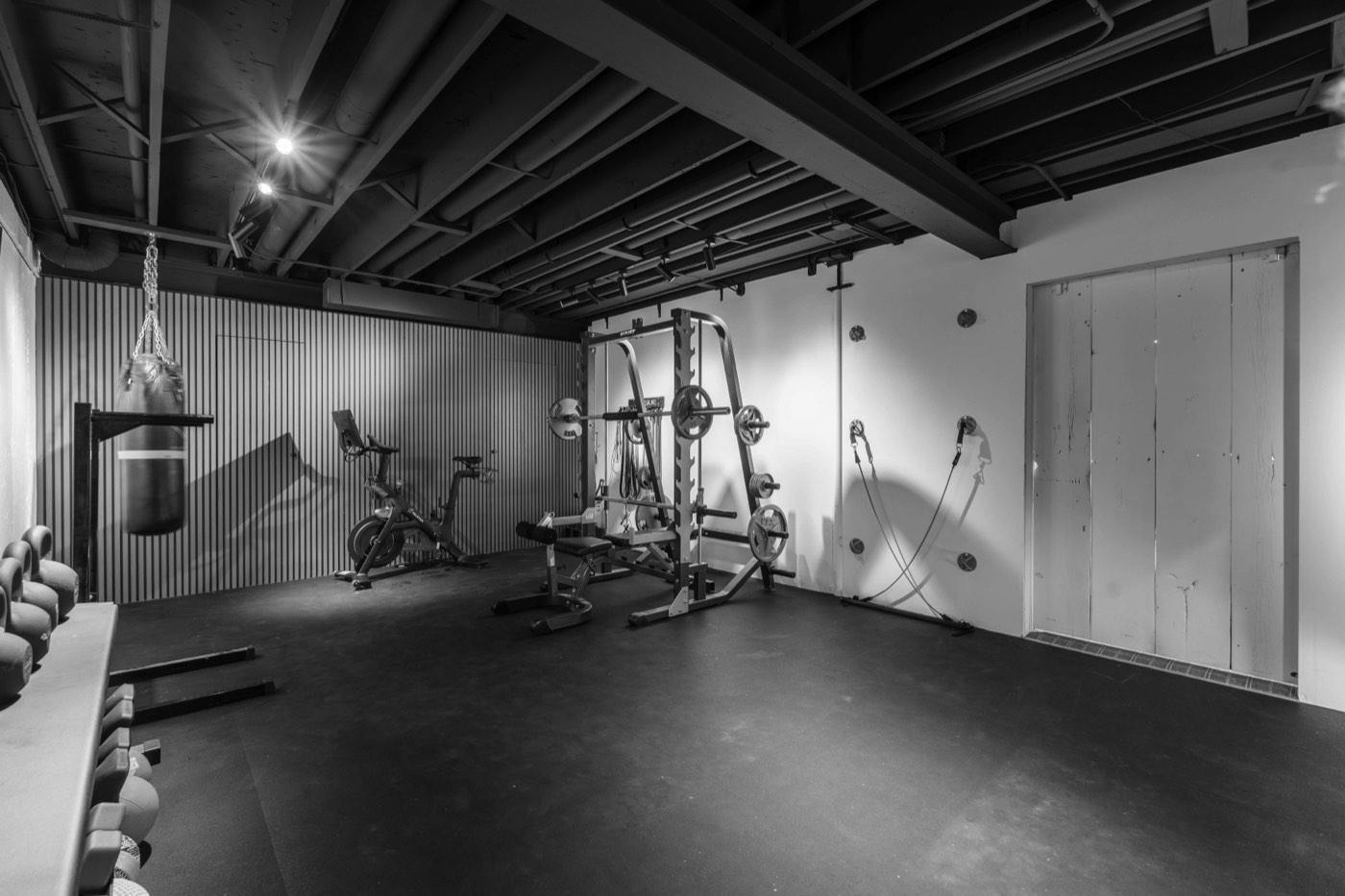 Basement home gym renovation with blacked-out ceiling and acoustic wood wall, Chicago